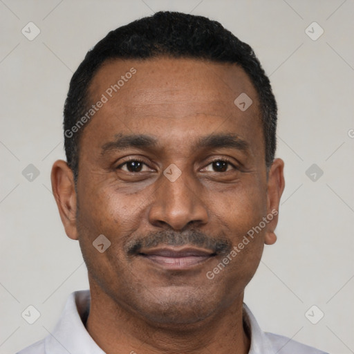 Joyful black adult male with short  black hair and brown eyes