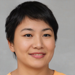 Joyful asian young-adult female with short  brown hair and brown eyes