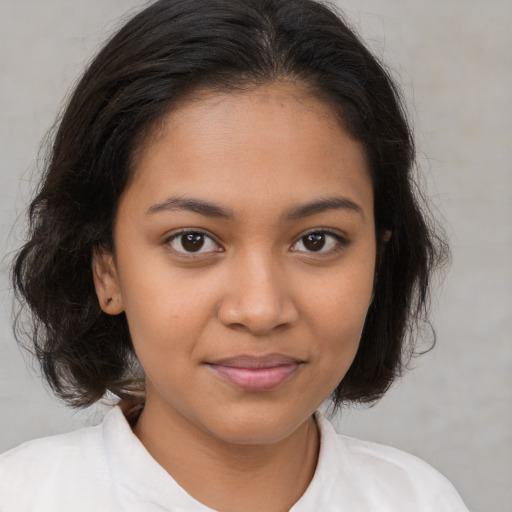 Joyful latino young-adult female with medium  brown hair and brown eyes