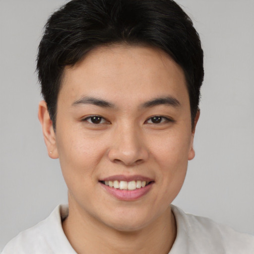 Joyful asian young-adult female with short  brown hair and brown eyes