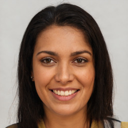 Joyful latino young-adult female with long  brown hair and brown eyes