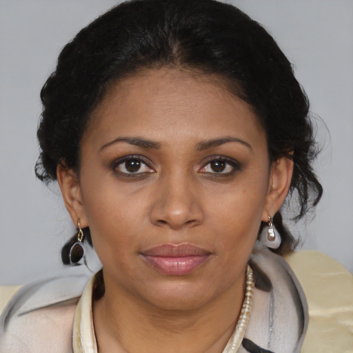 Joyful black young-adult female with medium  brown hair and brown eyes