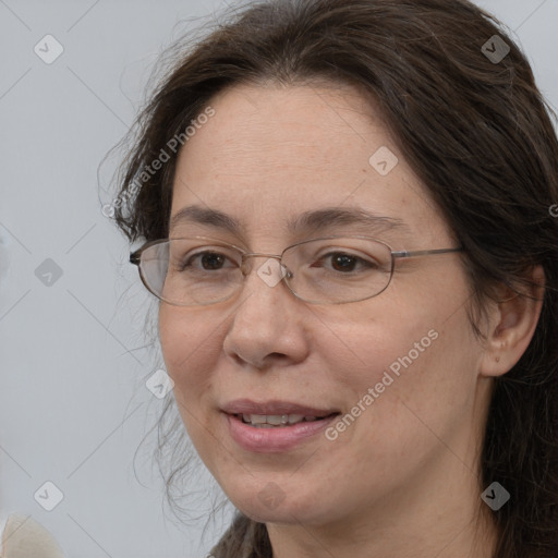 Joyful white adult female with long  brown hair and brown eyes