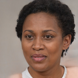 Joyful black adult female with short  brown hair and brown eyes