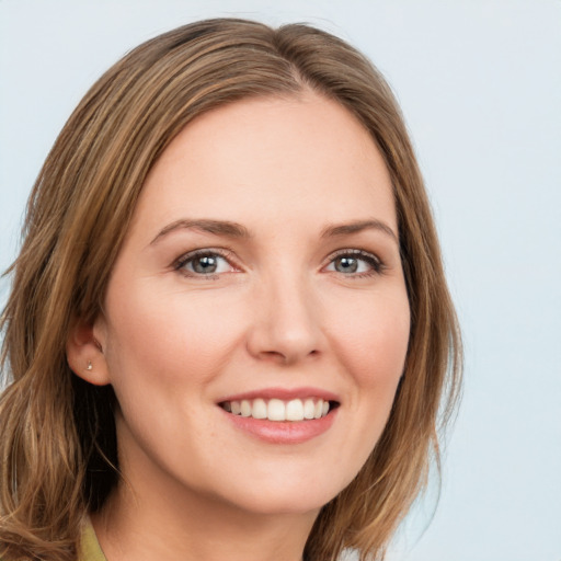 Joyful white young-adult female with long  brown hair and green eyes