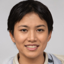 Joyful asian young-adult female with short  brown hair and brown eyes