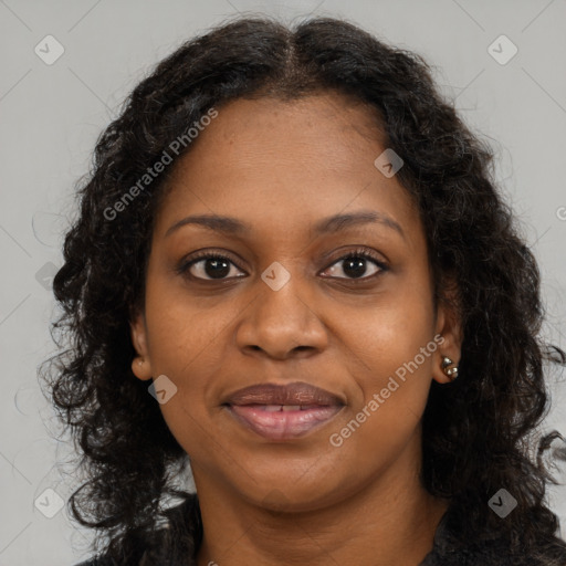 Joyful black young-adult female with long  brown hair and brown eyes