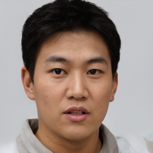Neutral asian young-adult male with short  black hair and brown eyes