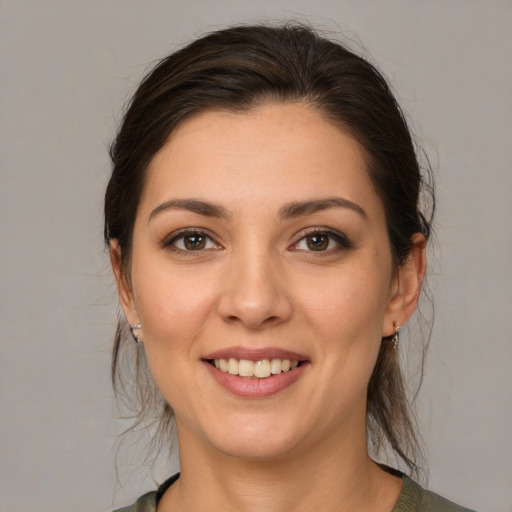 Joyful white young-adult female with medium  brown hair and brown eyes