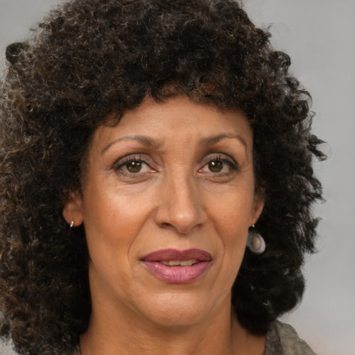 Joyful black adult female with medium  brown hair and brown eyes