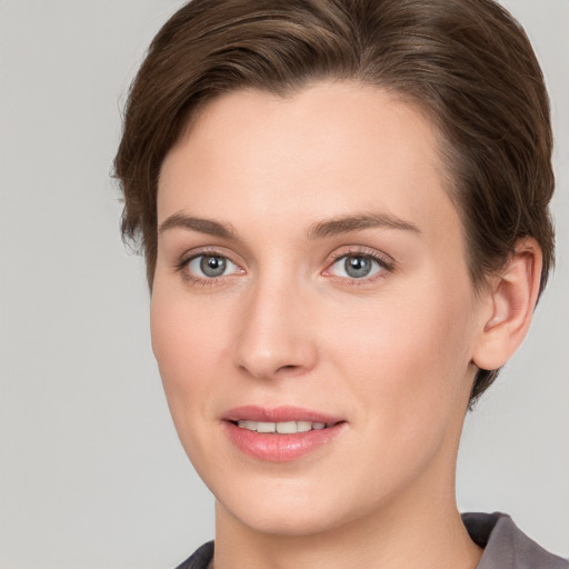 Joyful white young-adult female with short  brown hair and grey eyes