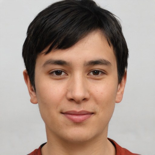 Joyful asian young-adult male with short  brown hair and brown eyes