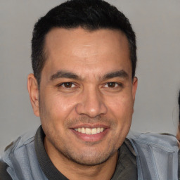 Joyful white adult male with short  brown hair and brown eyes