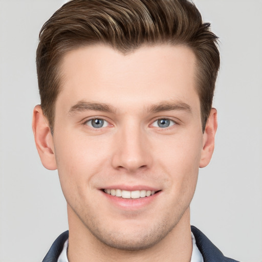 Joyful white young-adult male with short  brown hair and grey eyes