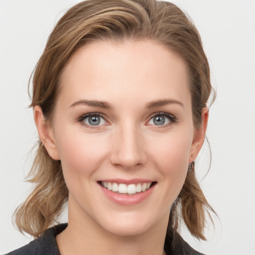 Joyful white young-adult female with medium  brown hair and grey eyes