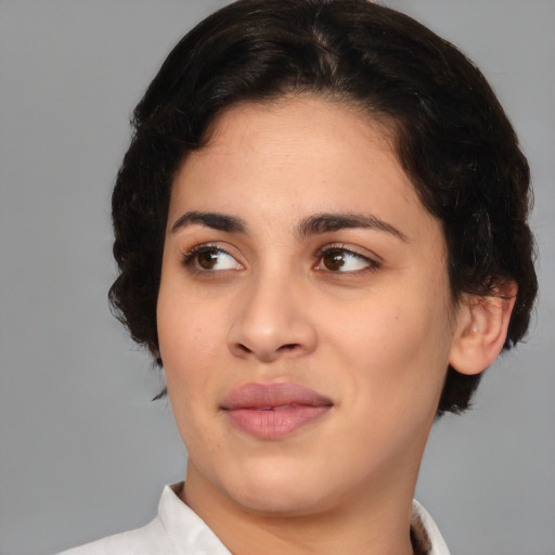 Joyful latino young-adult female with medium  brown hair and brown eyes