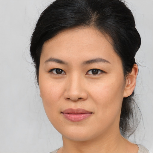 Joyful asian young-adult female with medium  brown hair and brown eyes