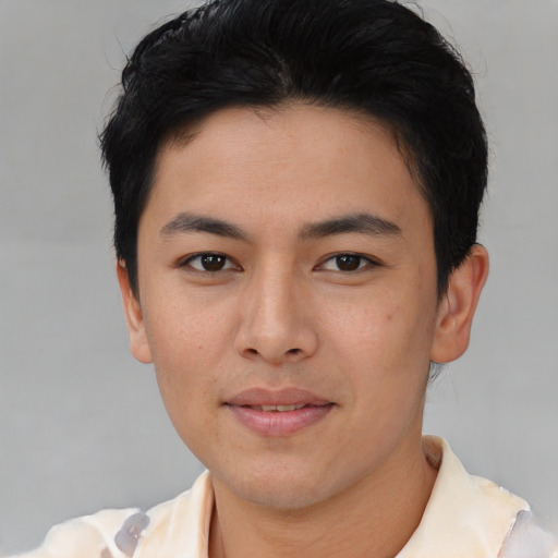 Joyful asian young-adult male with short  black hair and brown eyes