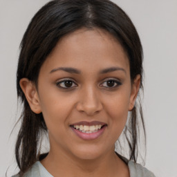 Joyful latino young-adult female with medium  brown hair and brown eyes