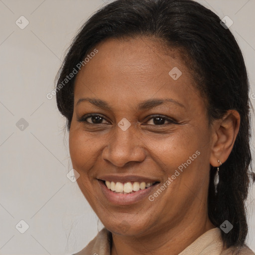 Joyful black adult female with medium  brown hair and brown eyes