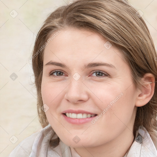 Joyful white young-adult female with medium  brown hair and blue eyes