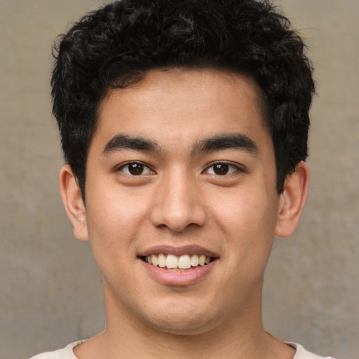 Joyful latino young-adult male with short  brown hair and brown eyes