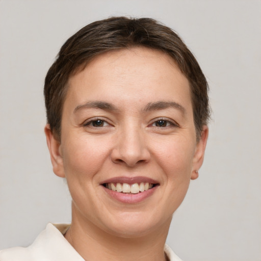 Joyful white young-adult female with short  brown hair and brown eyes