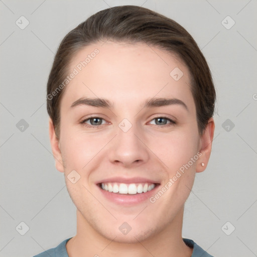 Joyful white young-adult female with short  brown hair and grey eyes