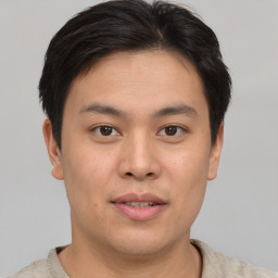 Joyful asian young-adult male with short  brown hair and brown eyes