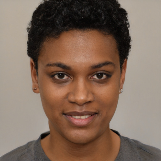 Joyful black young-adult female with short  black hair and brown eyes