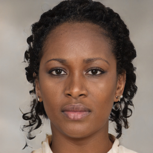 Neutral black young-adult female with medium  brown hair and brown eyes