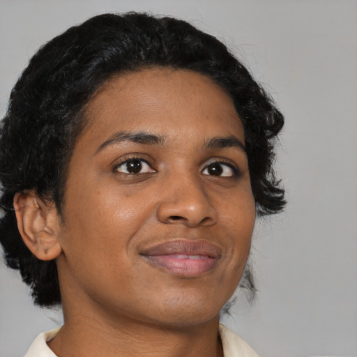 Joyful black young-adult female with medium  brown hair and brown eyes