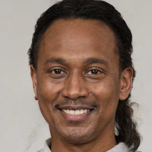 Joyful latino adult male with short  brown hair and brown eyes