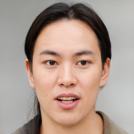 Joyful asian young-adult male with medium  brown hair and brown eyes