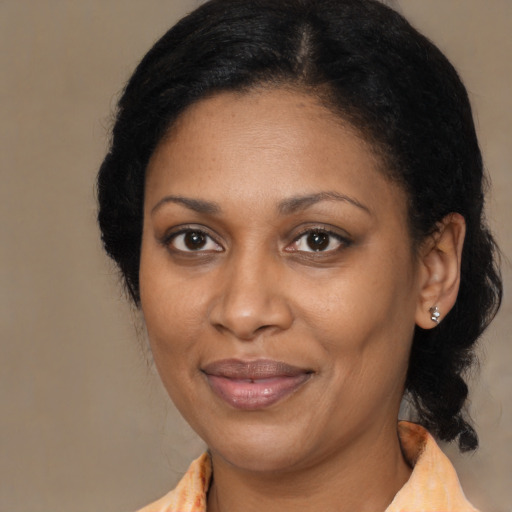 Joyful black adult female with medium  black hair and brown eyes