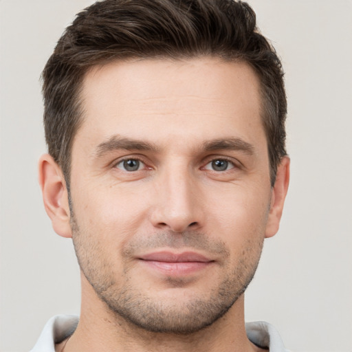 Joyful white young-adult male with short  brown hair and brown eyes