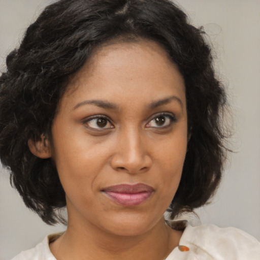 Joyful black young-adult female with medium  brown hair and brown eyes