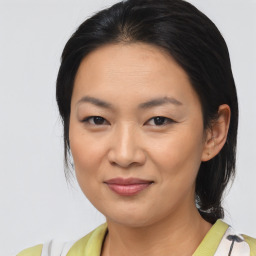 Joyful asian young-adult female with medium  brown hair and brown eyes