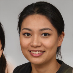 Joyful asian young-adult female with medium  brown hair and brown eyes