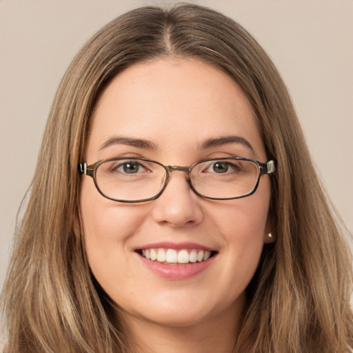 Joyful white young-adult female with long  brown hair and green eyes