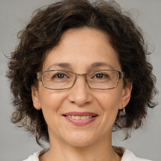 Joyful white adult female with medium  brown hair and brown eyes