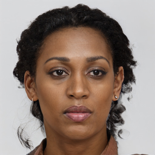 Neutral black young-adult female with long  brown hair and brown eyes