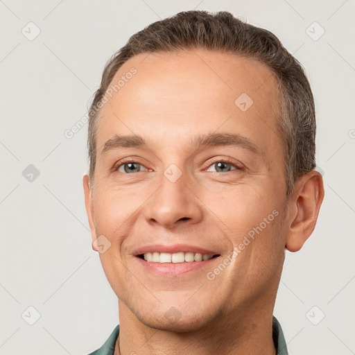 Joyful white adult male with short  brown hair and brown eyes