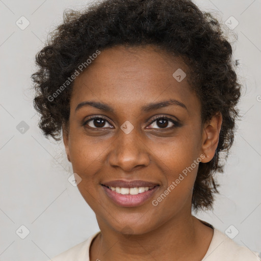 Joyful black young-adult female with short  brown hair and brown eyes