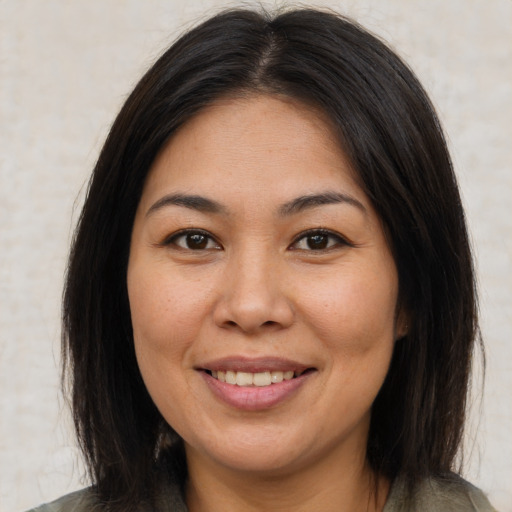 Joyful asian young-adult female with medium  brown hair and brown eyes