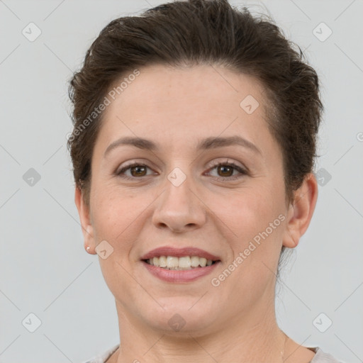 Joyful white adult female with short  brown hair and grey eyes