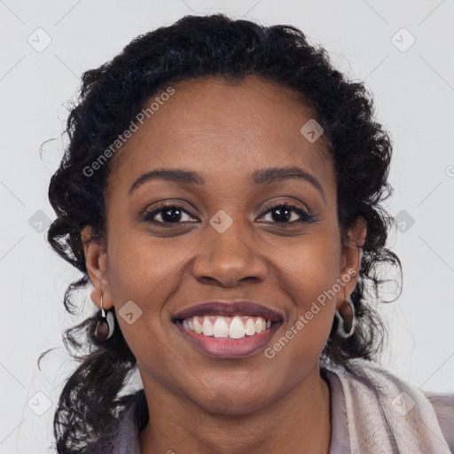 Joyful black young-adult female with long  brown hair and brown eyes