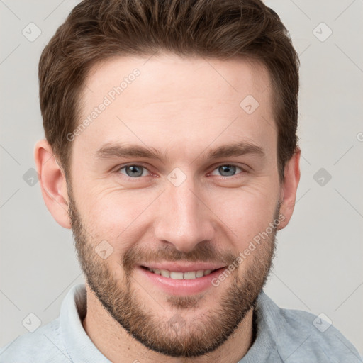 Joyful white young-adult male with short  brown hair and grey eyes