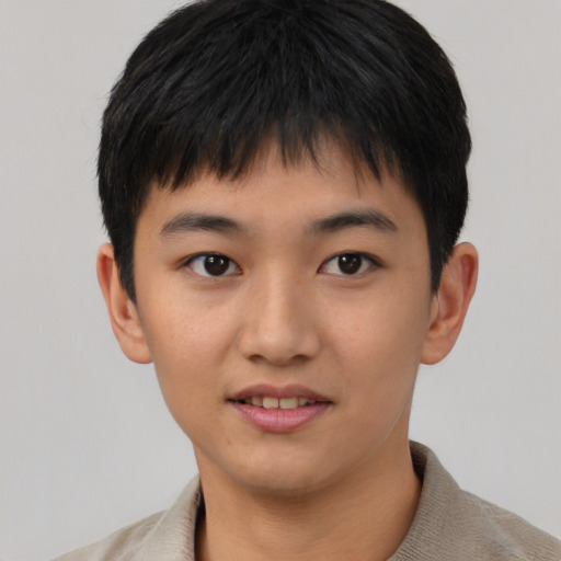 Joyful asian young-adult male with short  brown hair and brown eyes