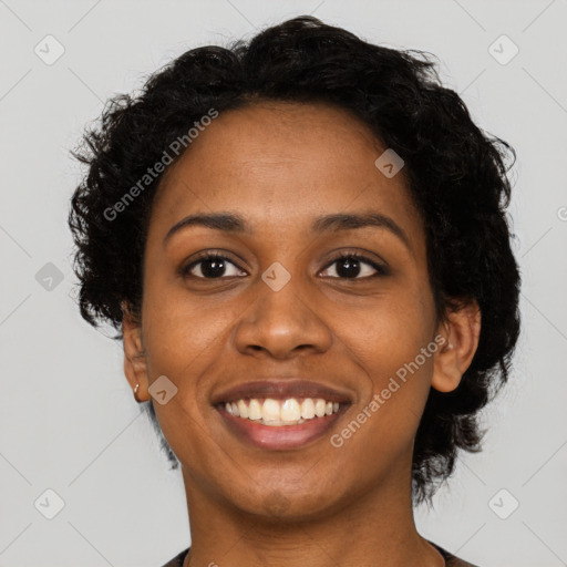 Joyful black young-adult female with short  black hair and brown eyes